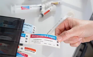 Label dispenser with syringe labels